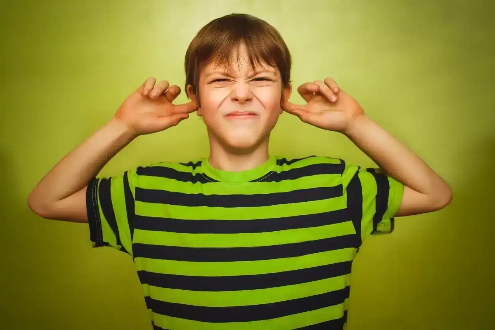 Boy Plugging his ears with his hands